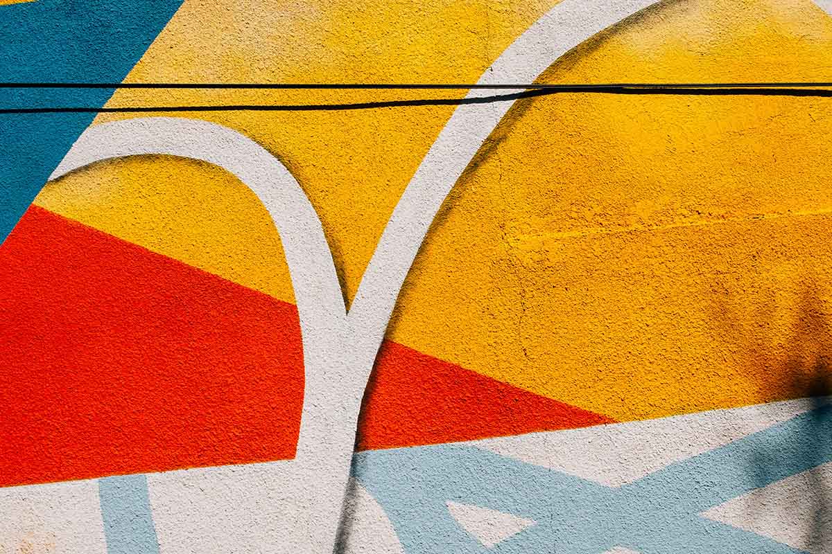 Close Up Of A Painted Cement Wall With Splashes Of Colour
