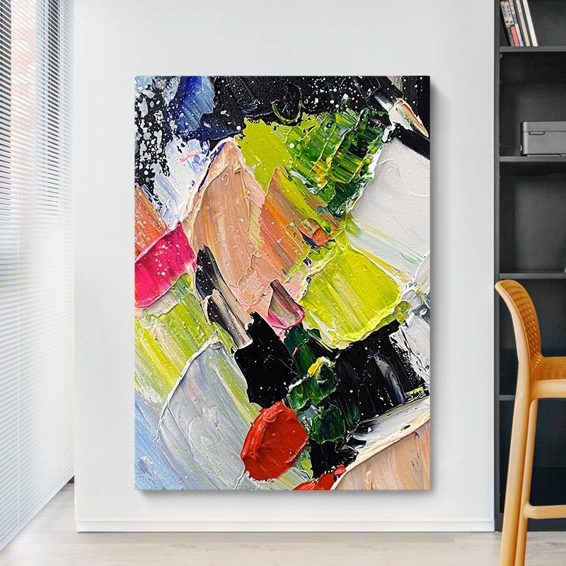 Frameless amber colorful hanging painting next to the bookshelf