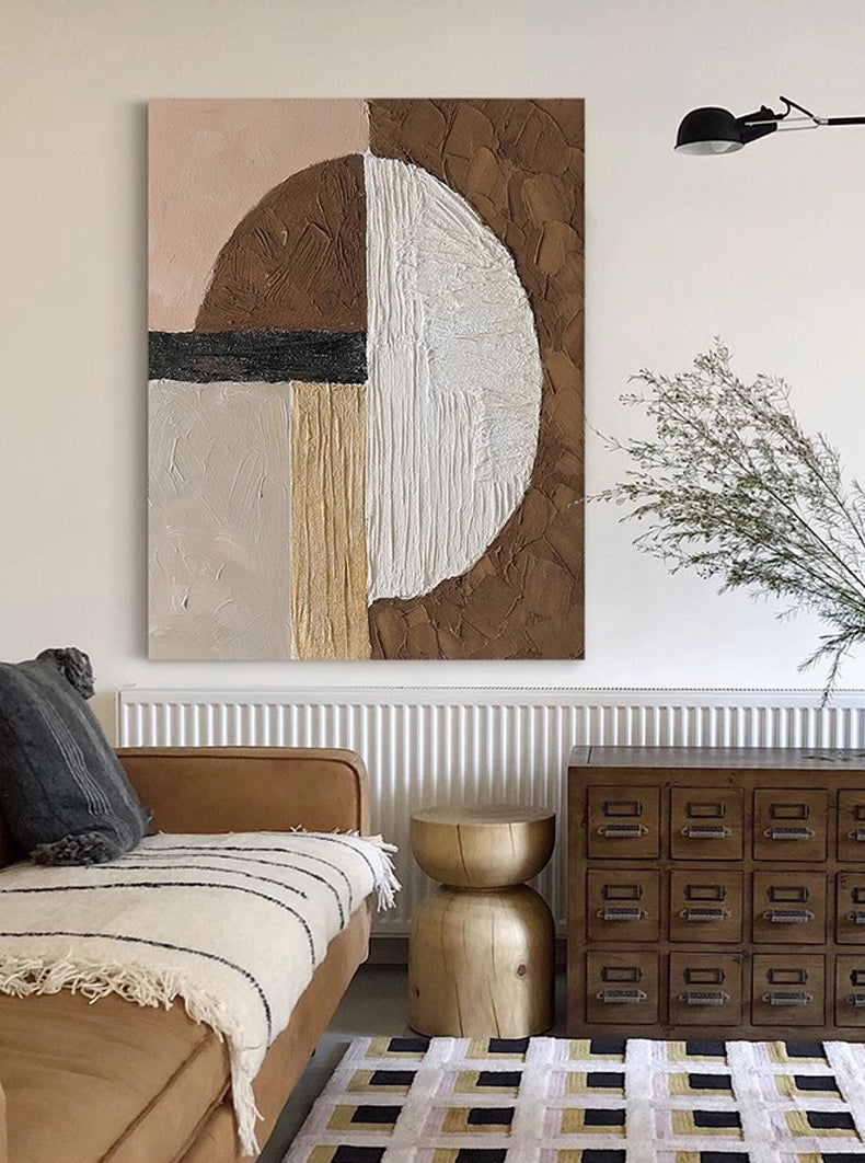 Frameless wabi-sabi art hanging on white storage cabinet in living room