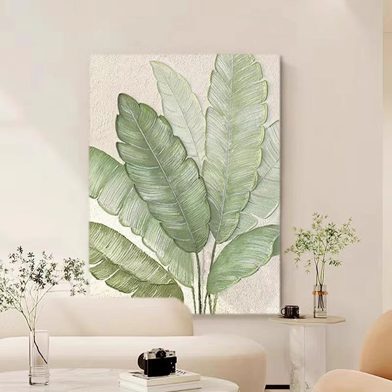 Simple painting of large green leaves on the background wall of the living room sofa