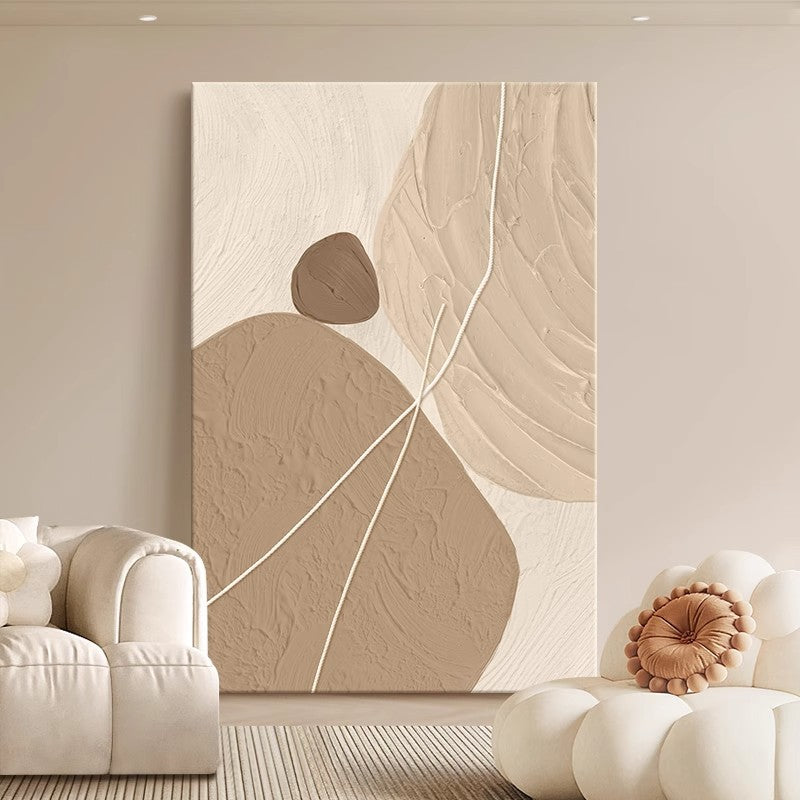 The stone-turning wabi-sabi texture floor painting behind the creamy white sofa