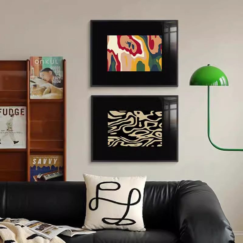 Two murals on the wall behind the black sofa in the living room SenroArt